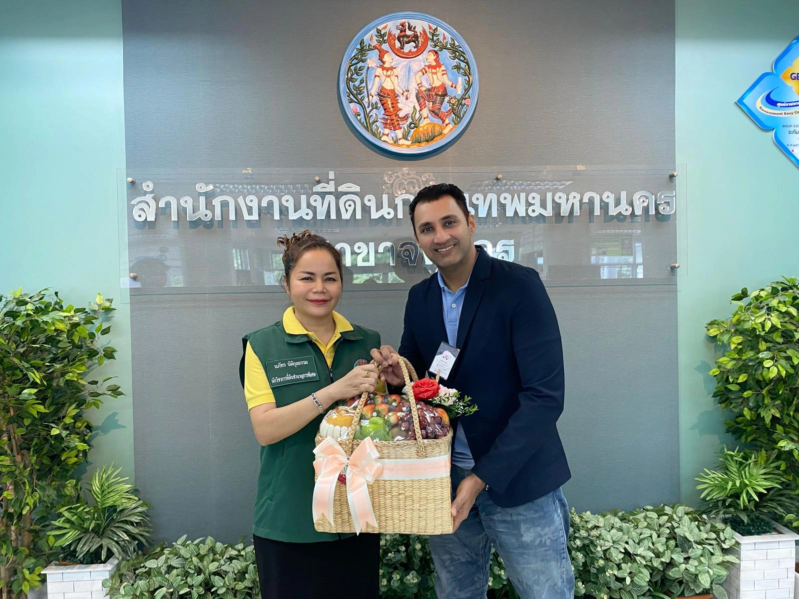 Roger Khera handing a gift hamper to a happy Thai client after closing an overseas property deal in Thailand.